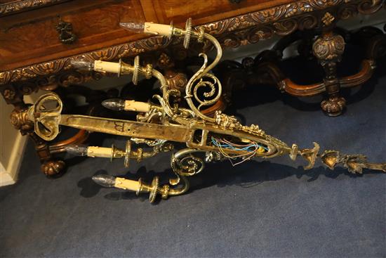 A pair of late Victorian ornate cast brass five branch wall lights, width 22in. depth 11in. height 39in.